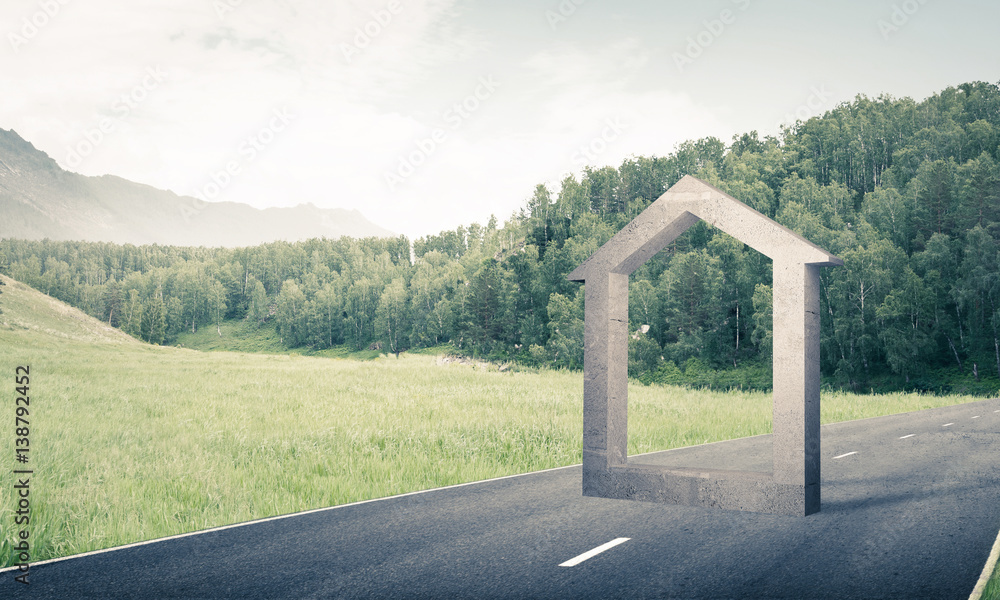 Conceptual background image of concrete home sign on asphalt roa