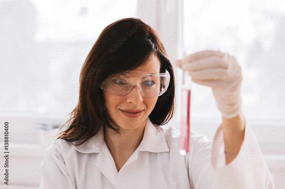 Medical researcher looking at test tube