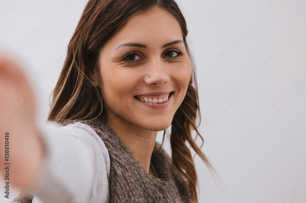 Cute smiling girl taking selfie