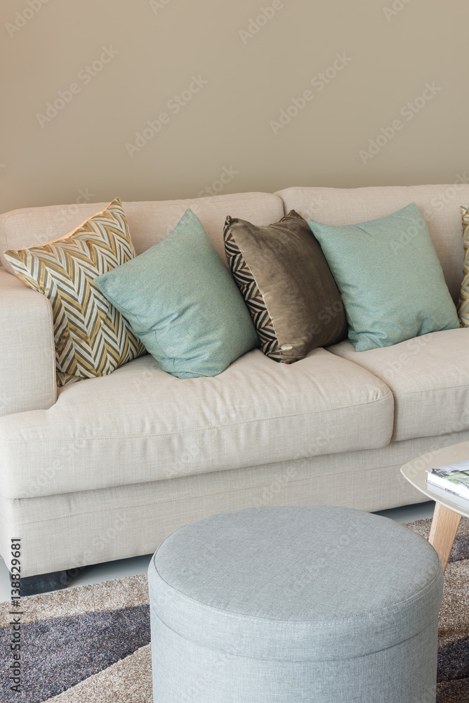 modern living room with green pillows on cozy sofa and wooden lamp