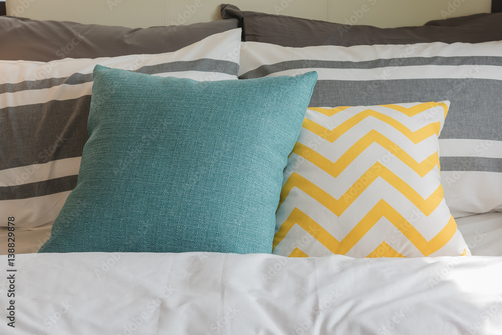 colorful pillows set on bed in modern bedroom