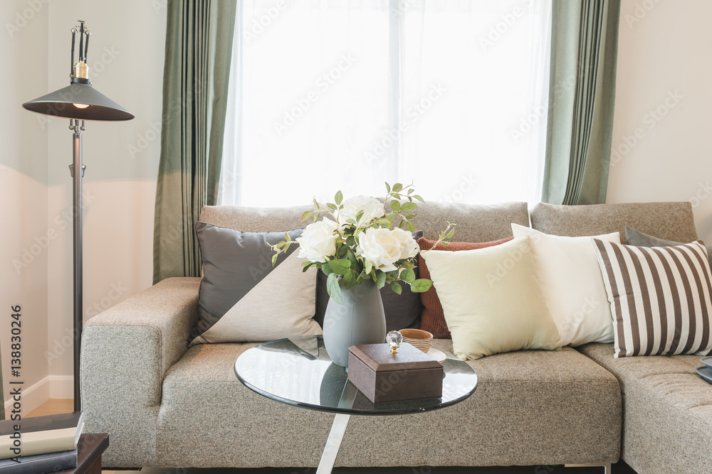 round glass table with set of sofa in modern living room