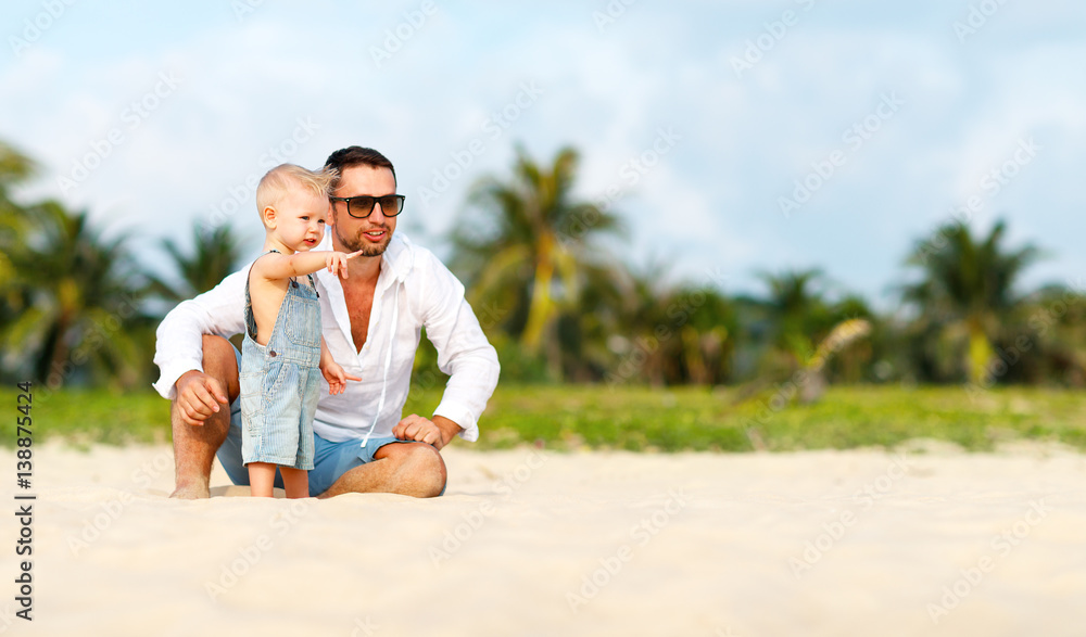 fathers day. Dad and baby son playing together outdoors on a summer