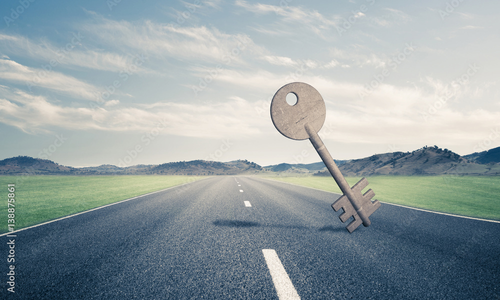 Conceptual background image of concrete key sign on asphalt road