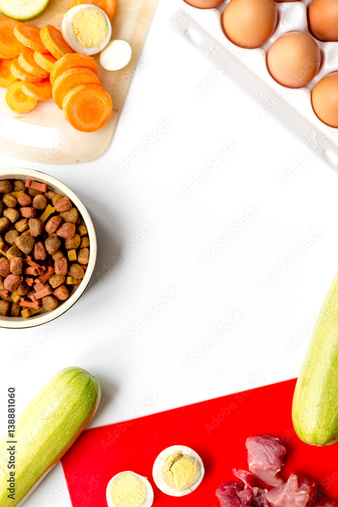 Food for pets with eggs and vegetables on kitchen top view mock-up