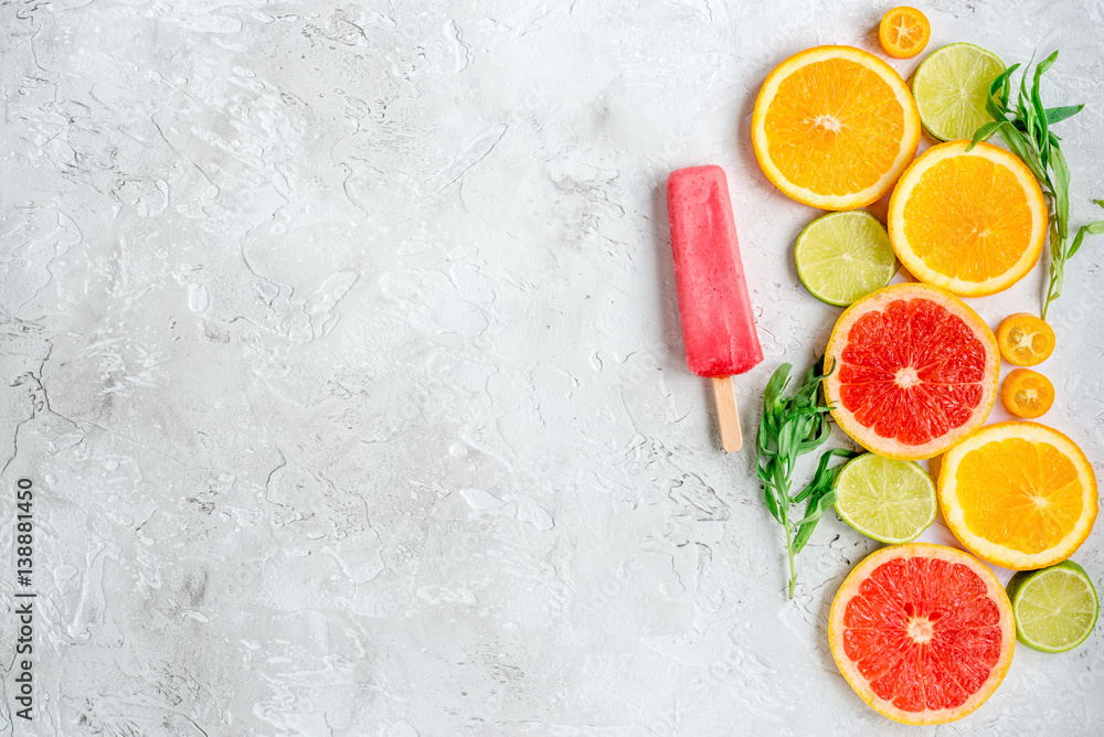 citrus popsicles with fruit slices on stone background top view mockup