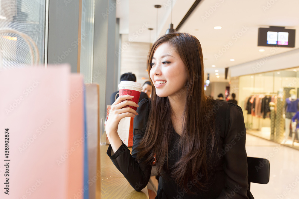 young asian woman shopping in modern shopping mall