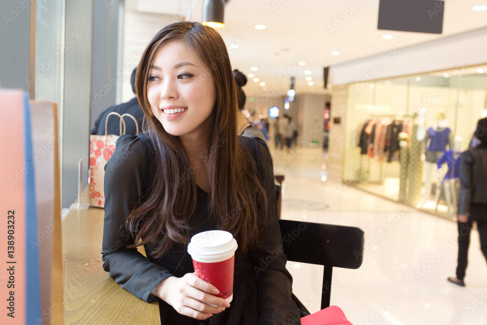 young asian woman shopping in modern shopping mall