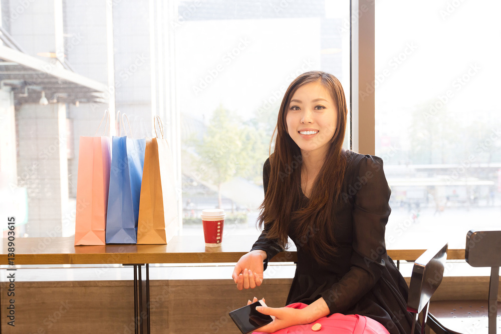 young asian woman shopping in modern shopping mall