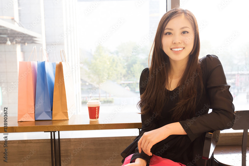 young asian woman shopping in modern shopping mall