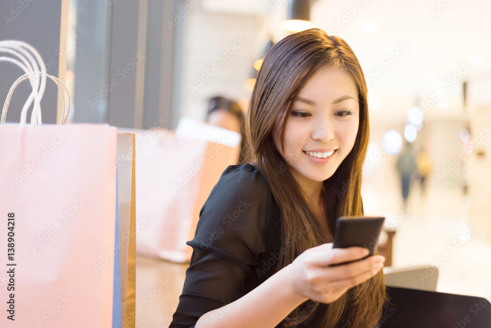 young asian woman shopping in modern shopping mall