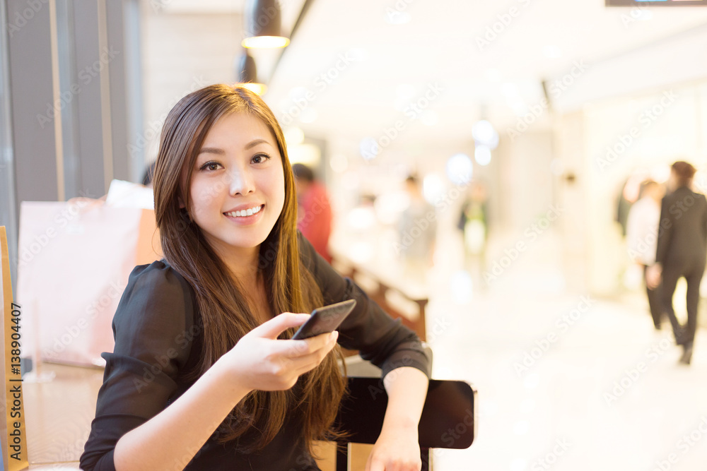 young asian woman shopping in modern shopping mall