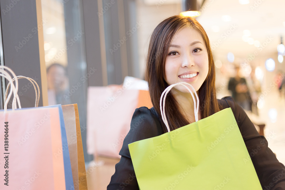 young asian woman shopping in modern shopping mall