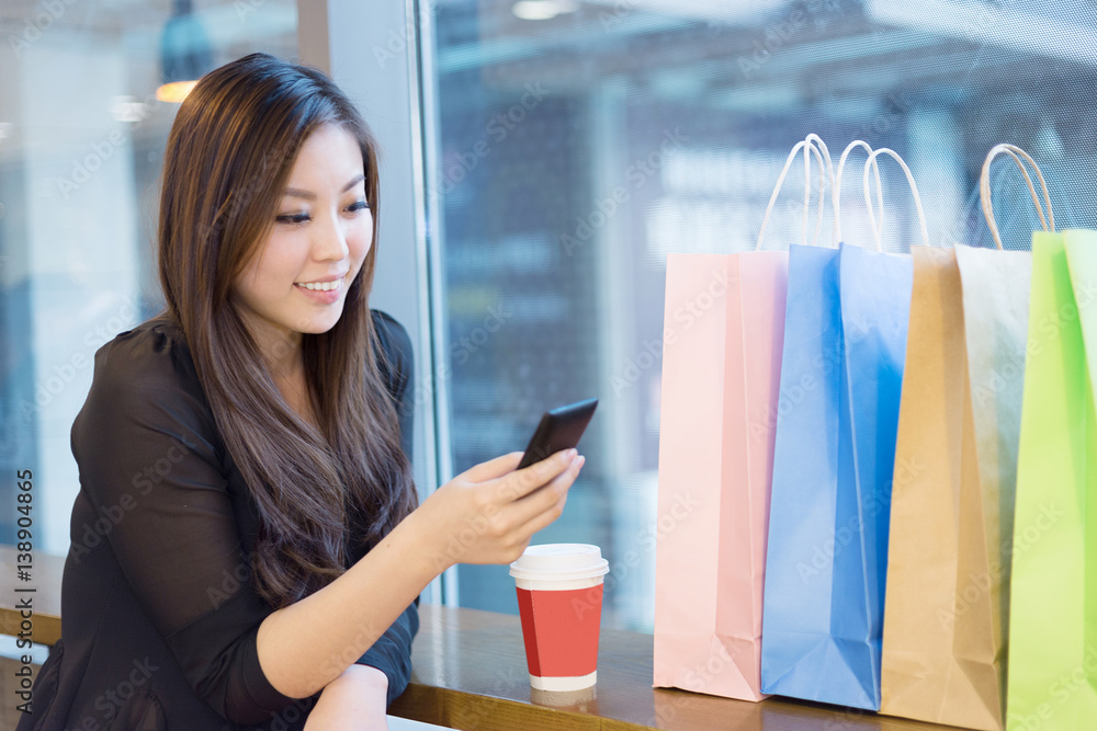 young asian woman shopping in modern shopping mall