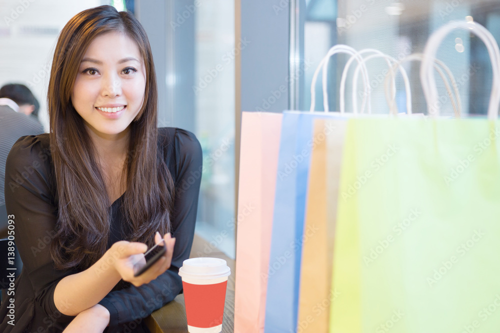 young asian woman shopping in modern shopping mall