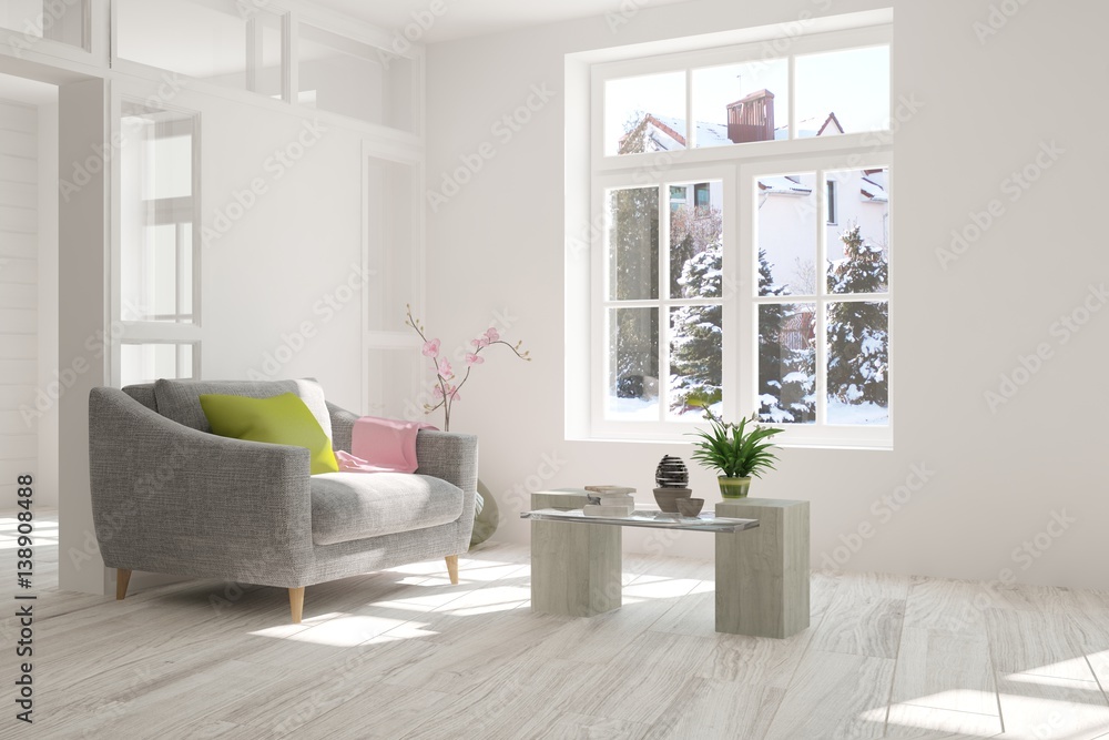 White room with armchair and winter landscape in window. Scandinavian interior design