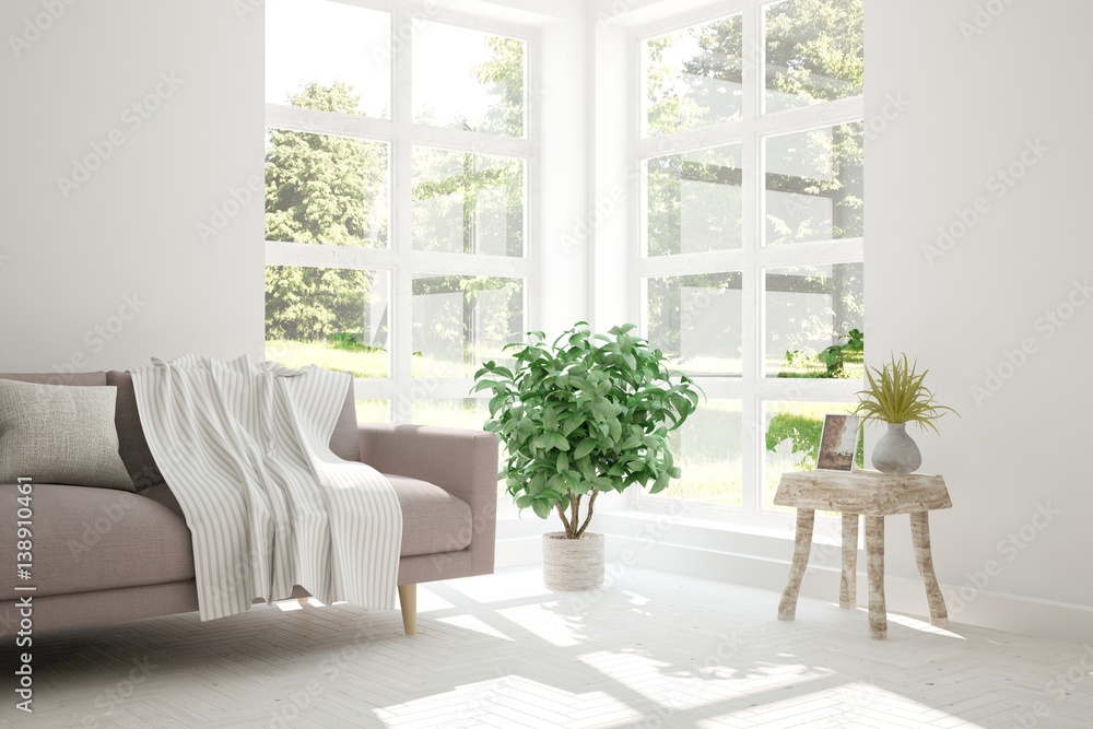 White room with sofa and green landscape in window. Scandinavian interior design