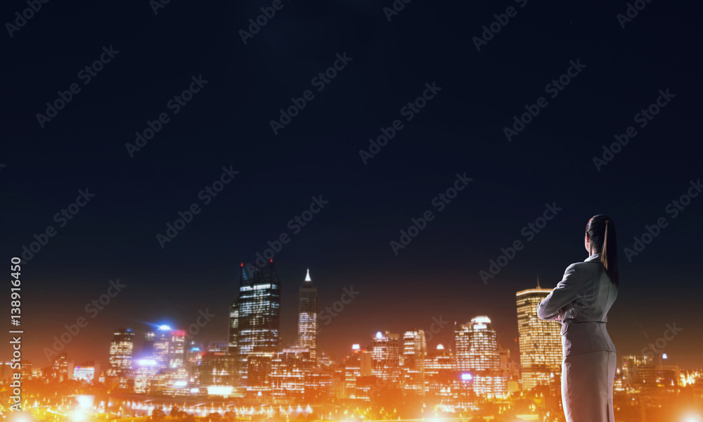 Woman looking at night city