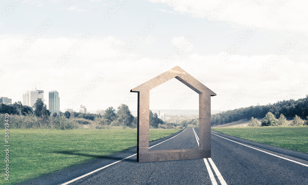 Conceptual background image of concrete home sign on asphalt roa