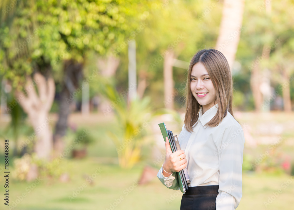 Portrait of young Asian business woman smiling outdoor