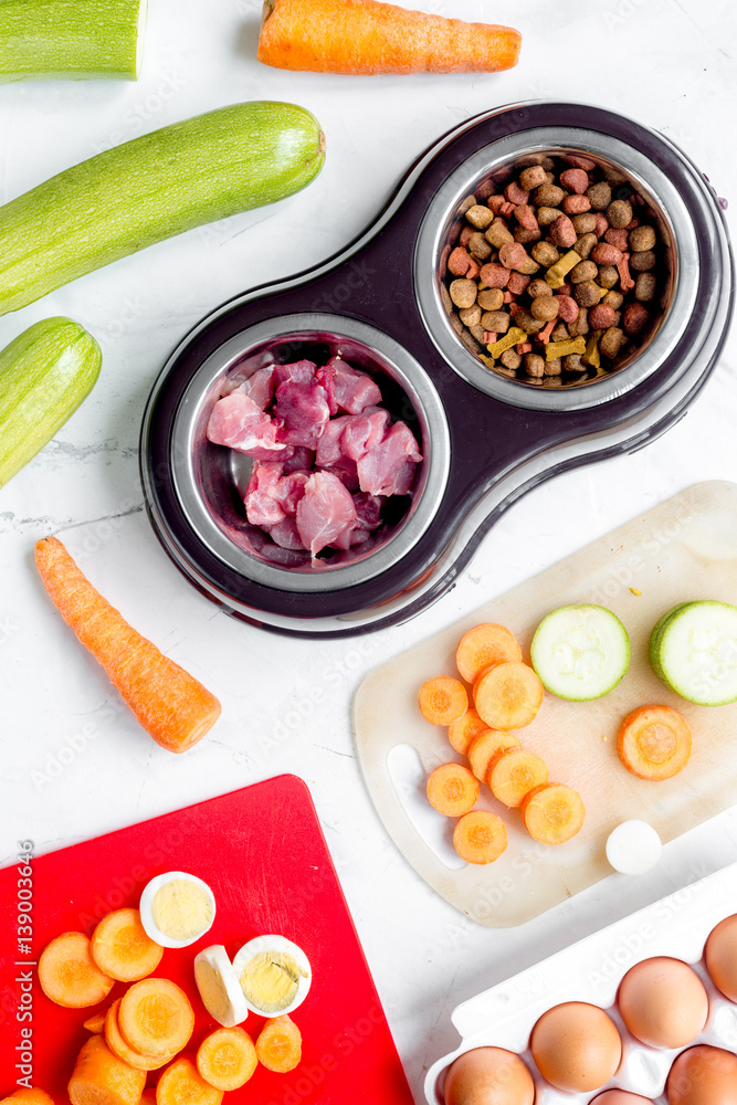 organic pets food with zucchini and carrot on table background top view