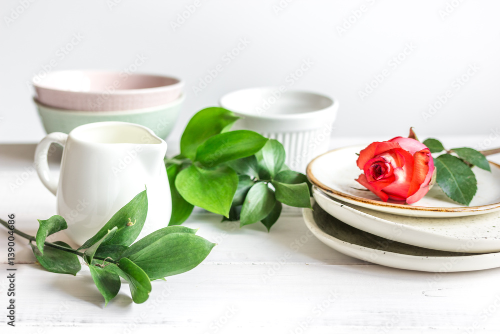 ceramic tableware with flowers on white background