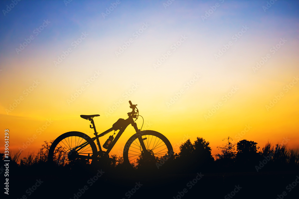 Silhouette Mountain biking at sunset. Photo Picture of a Mountai