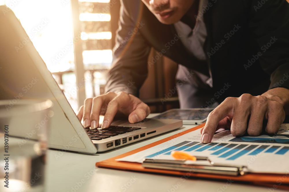 Businessman making presentation with his colleagues and business tablet digital computer at the offi