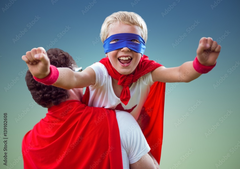 Father carrying a son in super hero costume