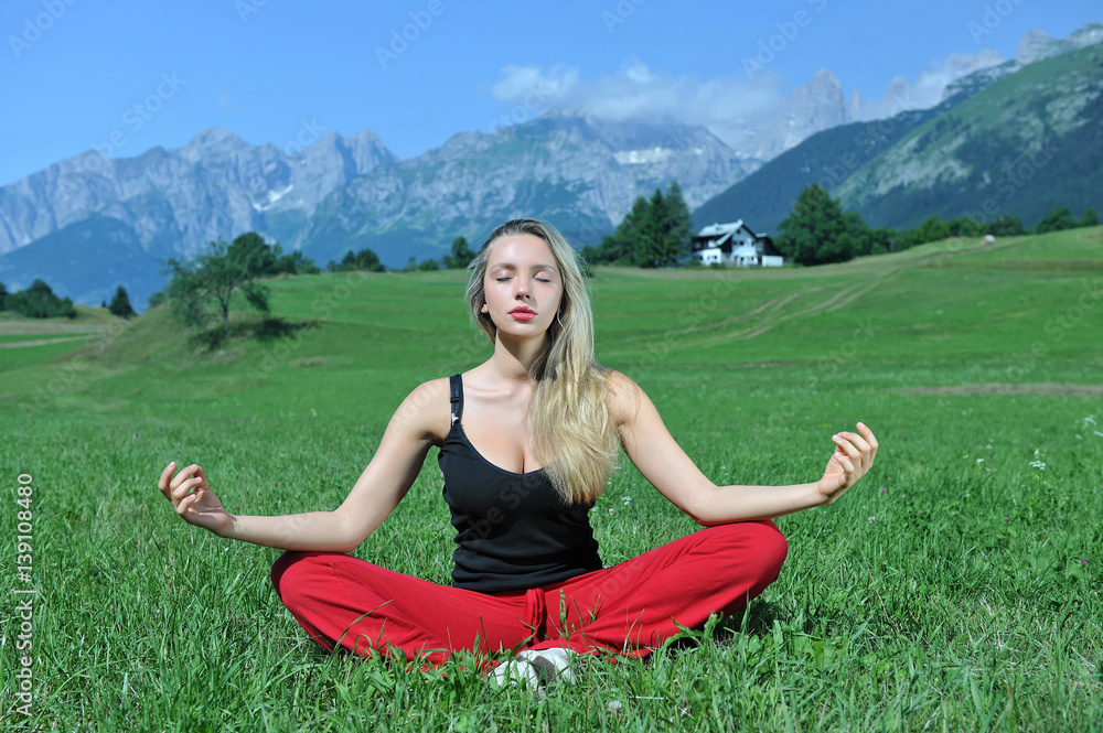 woman yoga relaxing by the mountains