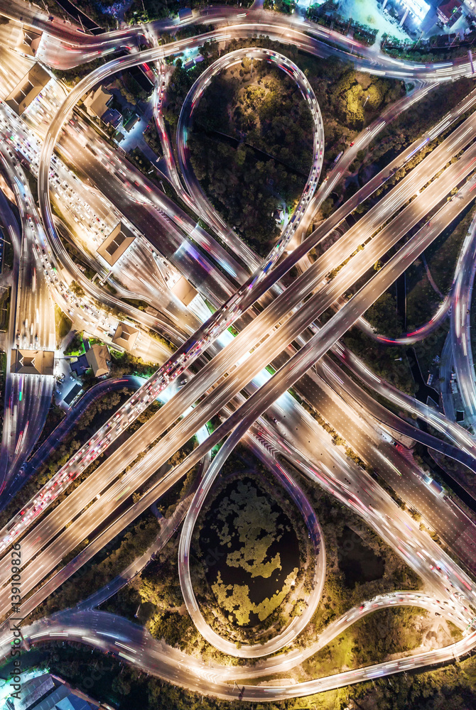 The light on the road  roundabout at night and the city in Bangkok, Thailand. Aerial view, Top view.