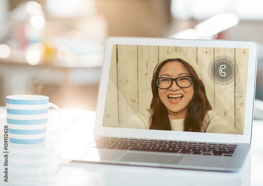 Laptop with smiling woman on video call screen