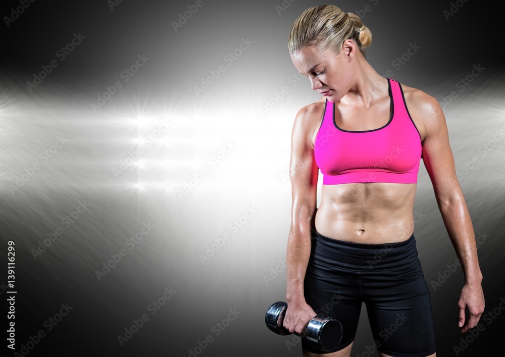 Healthy woman working out with dumb bells