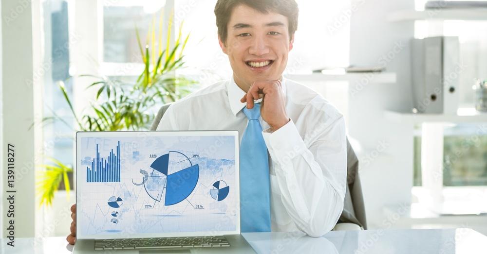 Businessman with laptop displaying graph charts on screen