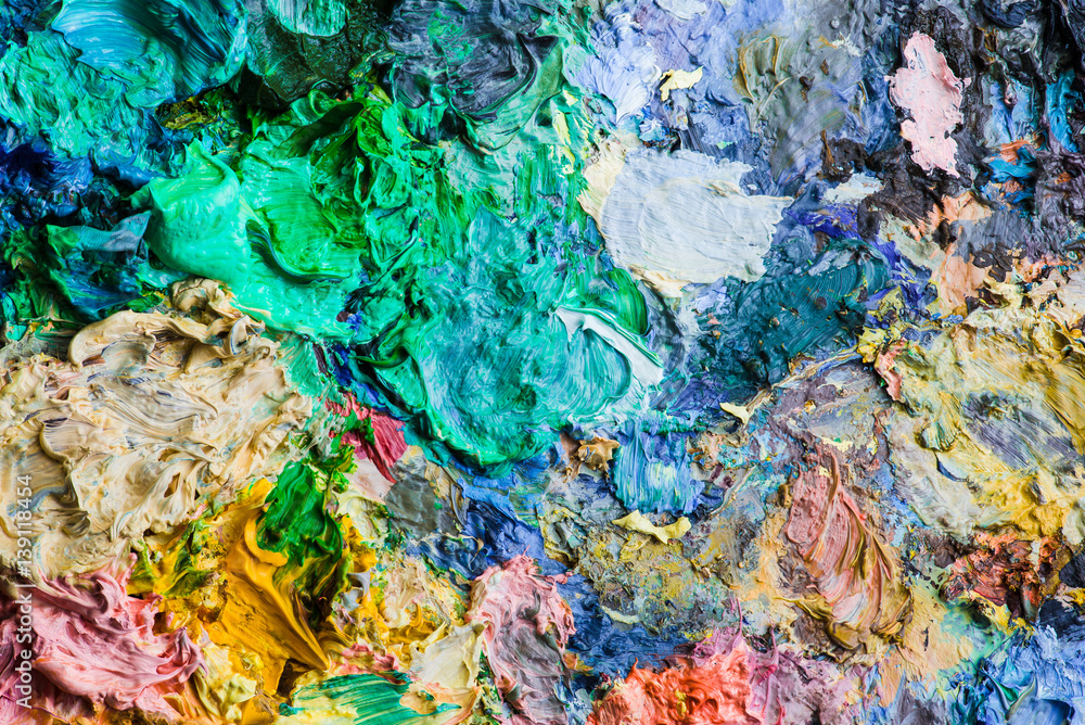 Background image of bright oil-paint palette closeup.