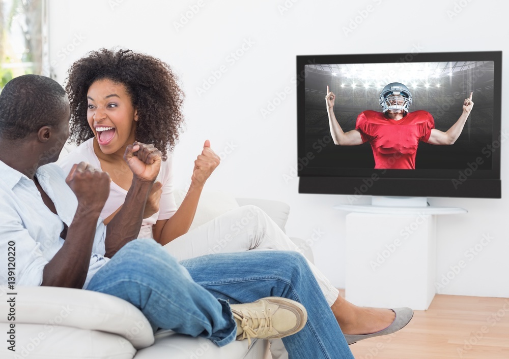 Couple watching american football at home