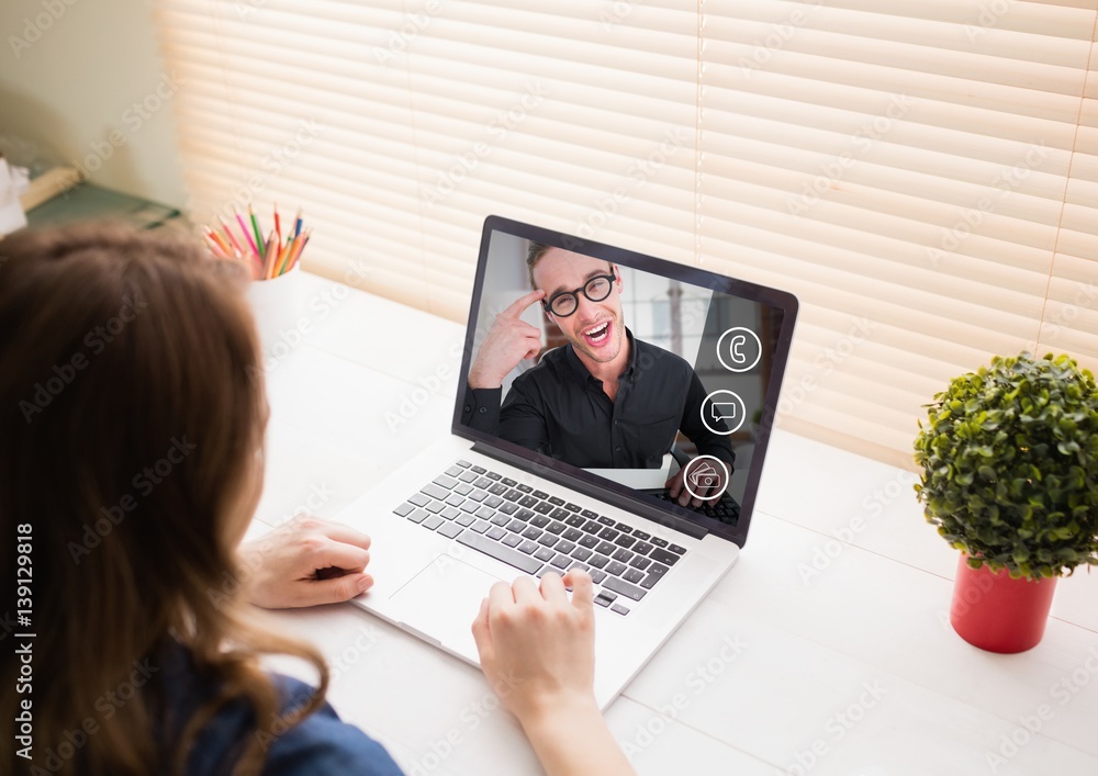 Woman having a video call with her friend on laptop