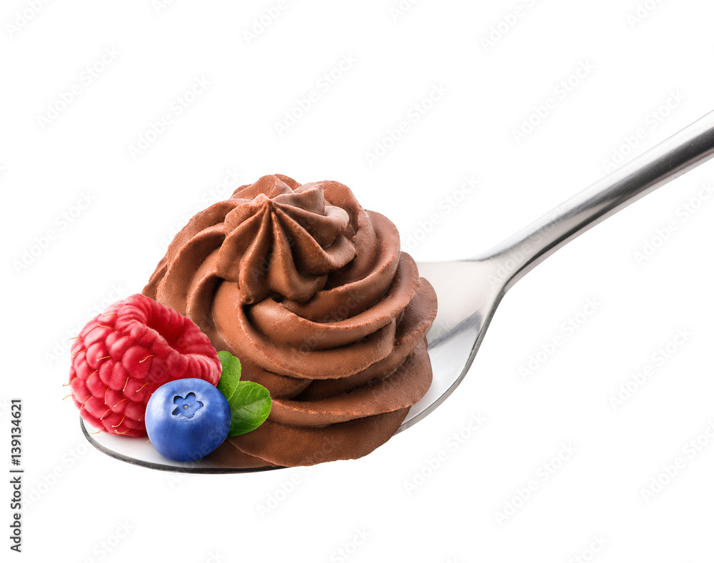 Chocolate frozen yogurt with fresh raspberry, blueberry and leaves on the spoon isolated by clipping