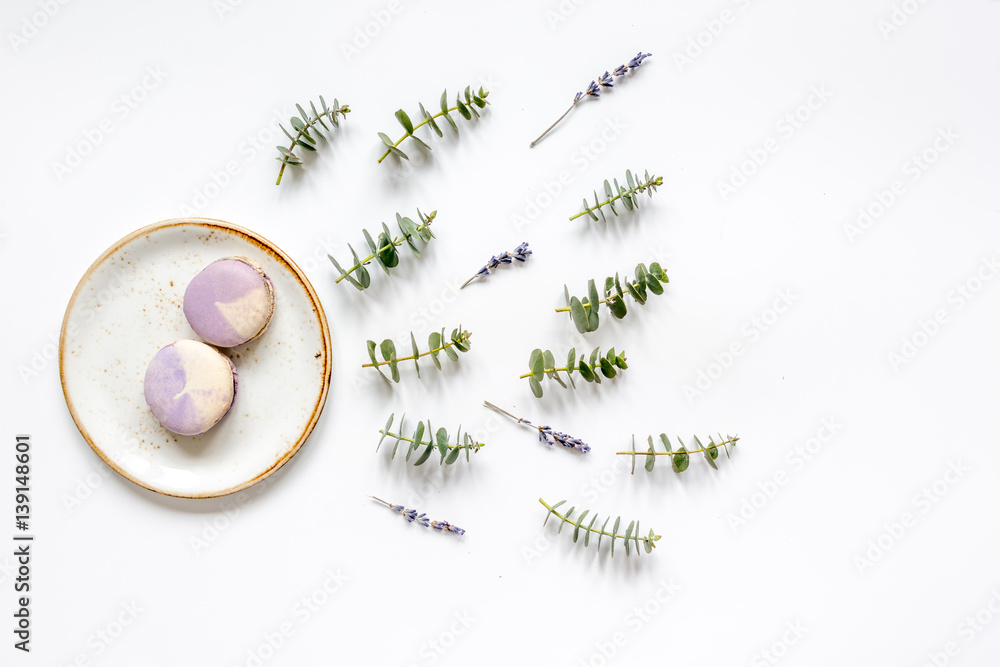 light breakfast with macaroons on spring pattern white background top view