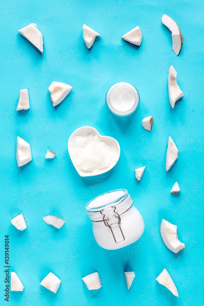 concept organic cosmetics with coconut on blue background top view