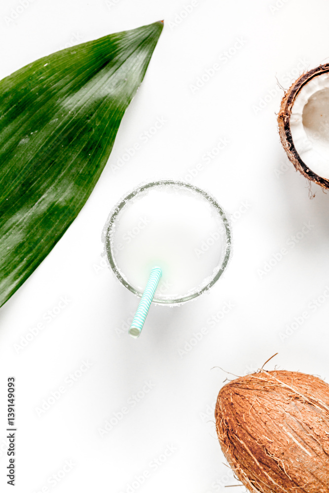 cocktail with coconut on white background top view