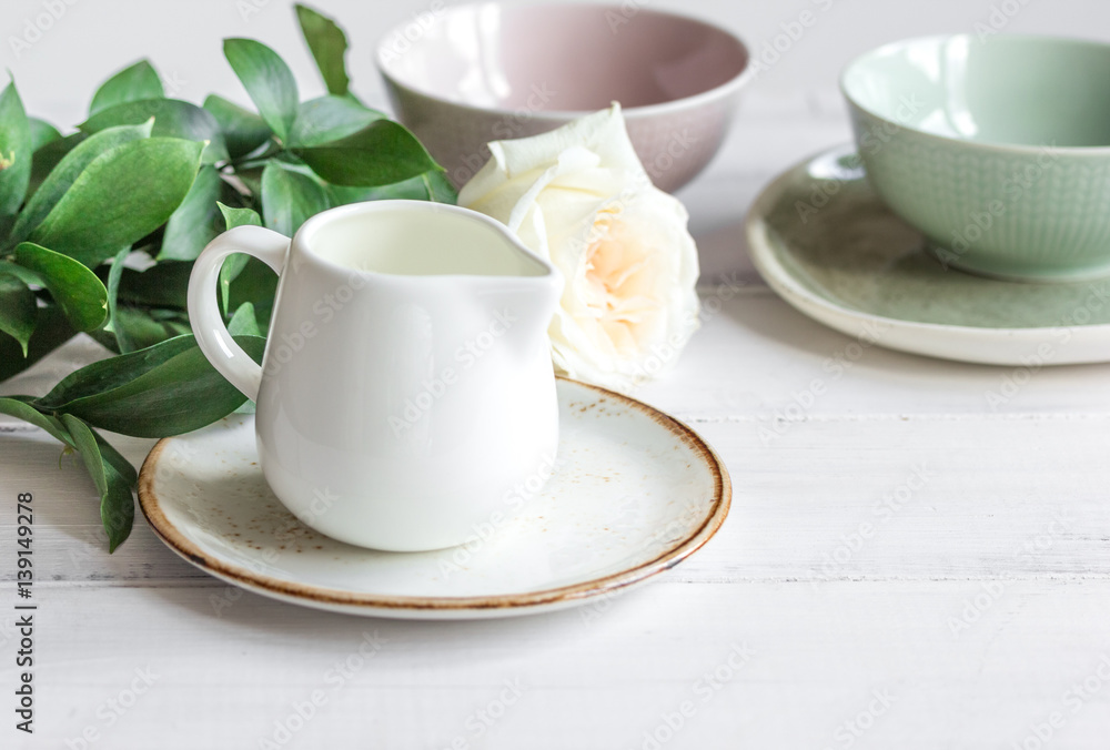 ceramic tableware with flowers on white background