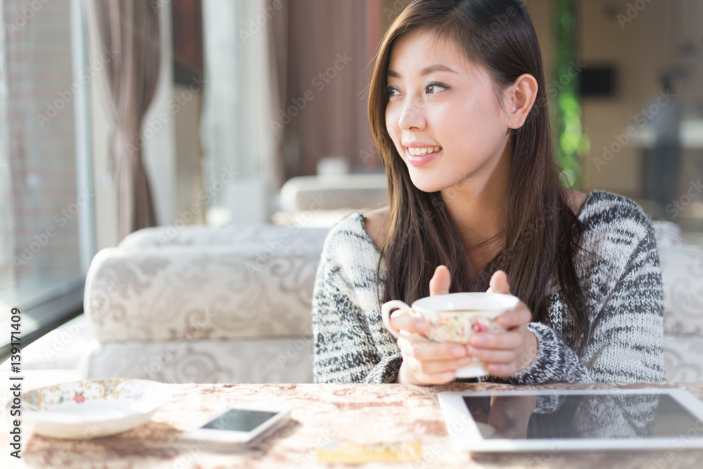 young pretty woman sits in modern cafe