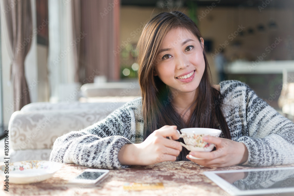 young pretty woman sits in modern cafe