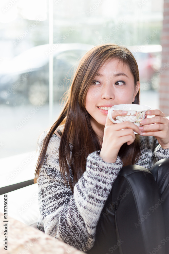 young pretty woman sits in cafe