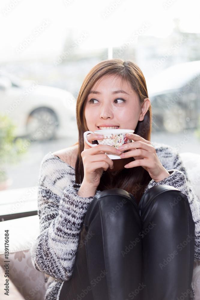 young pretty woman sits in cafe