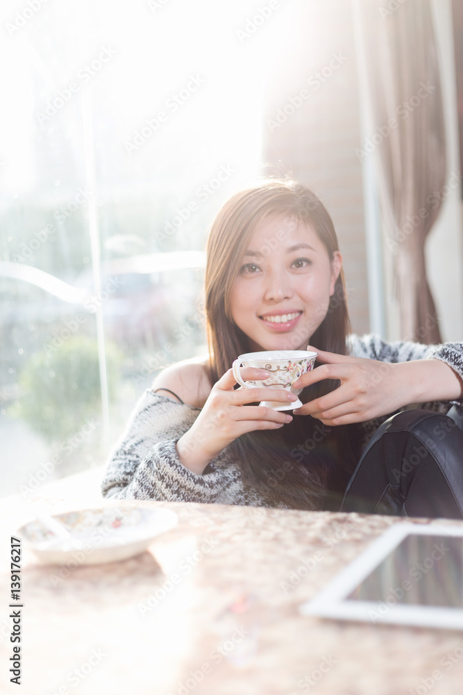 young pretty woman sits in cafe