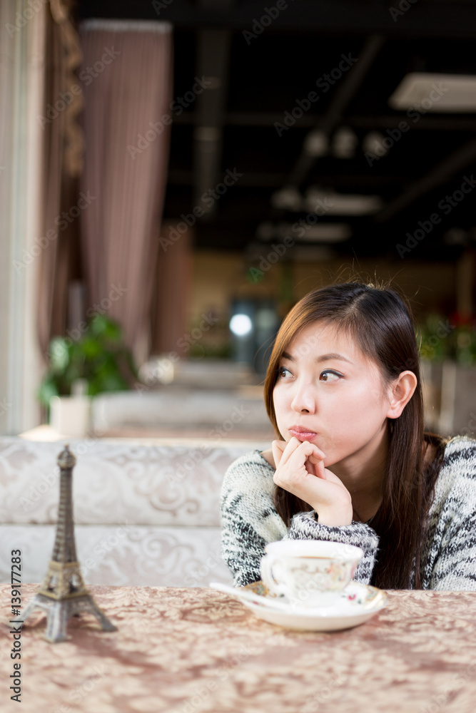 young pretty woman sits in cafe