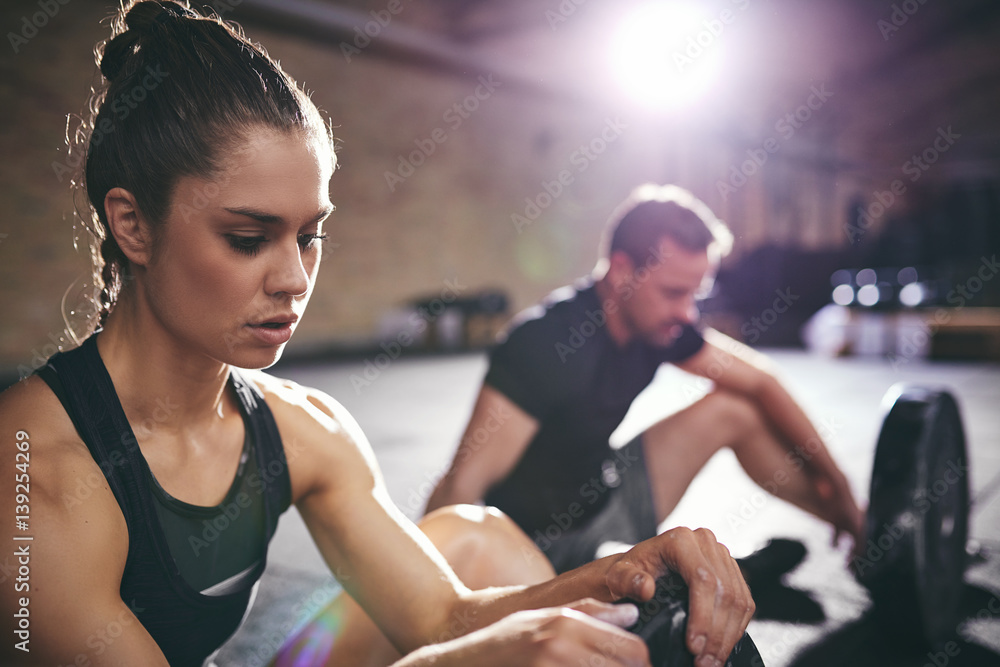 Fit man and woman resting after execise