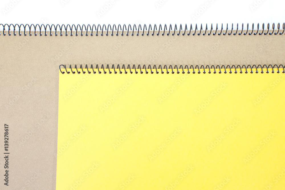 Yellow note book cover and brown note book on white background